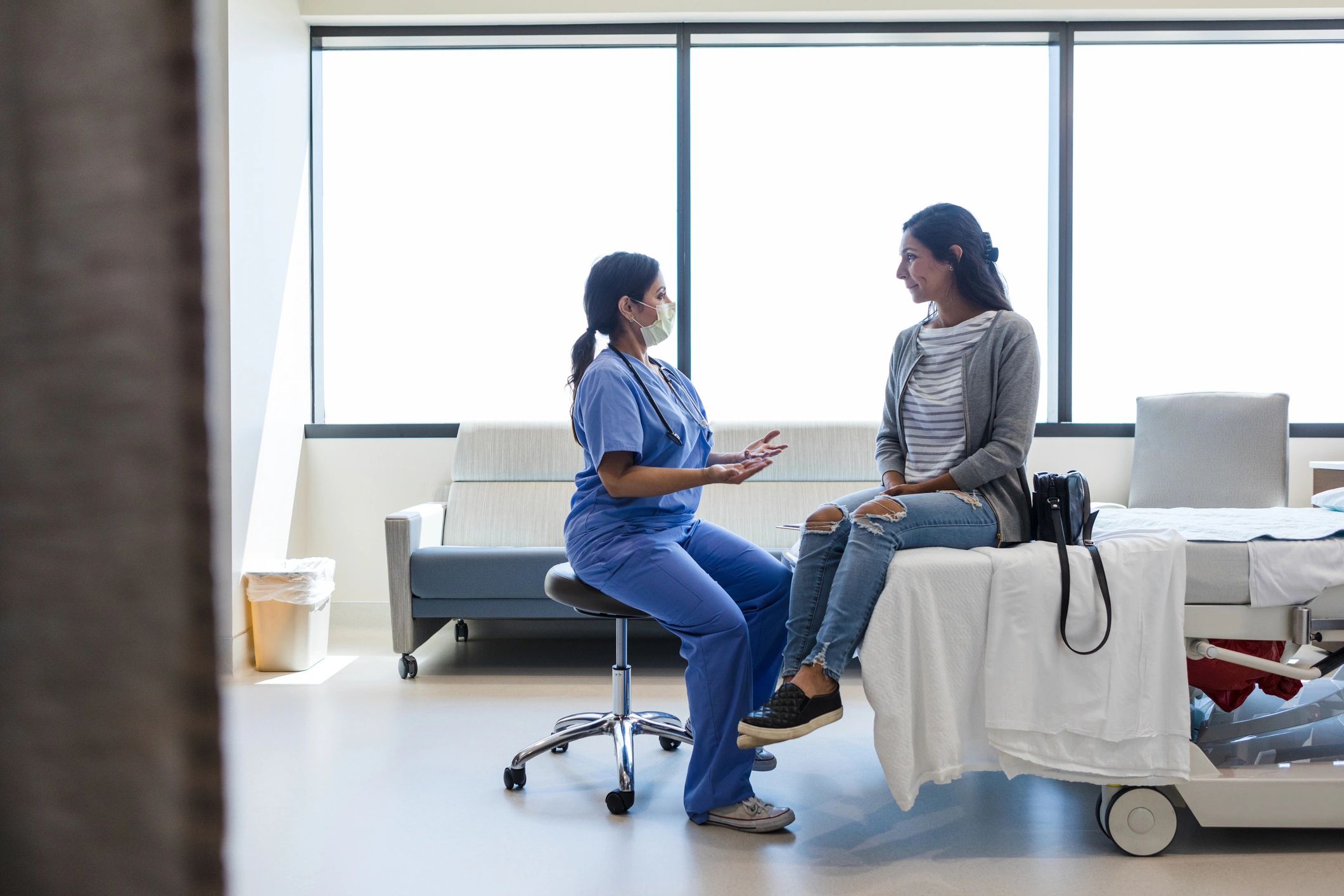 Doctor speaking with a patient in an exam room