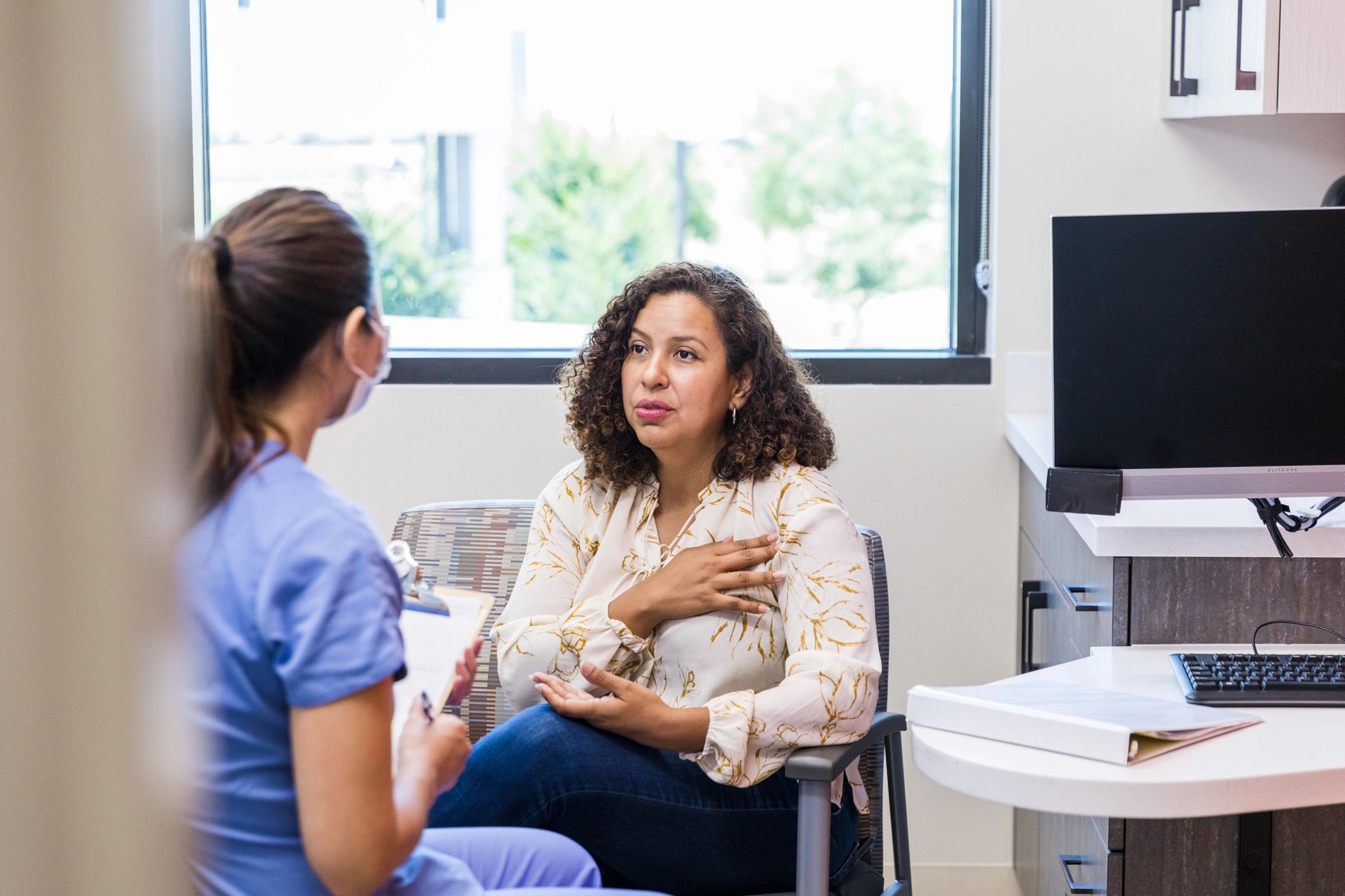 Nurse speaking with patient during a visit